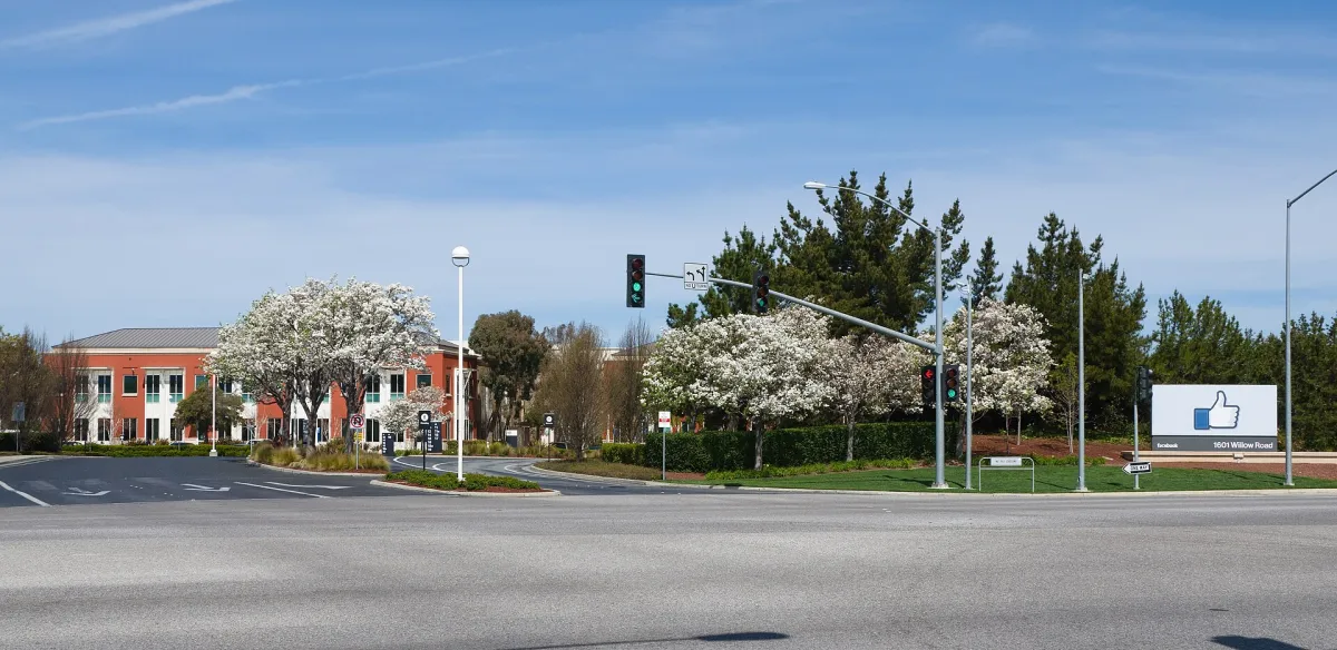 The Facebook headquarters sign and low office buildings at Menlo Park, California.