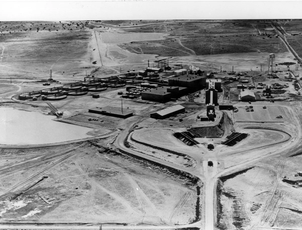 An aerial view of a Kerr-McGee uranium mill: low industrial buildings and settling ponds in open country.