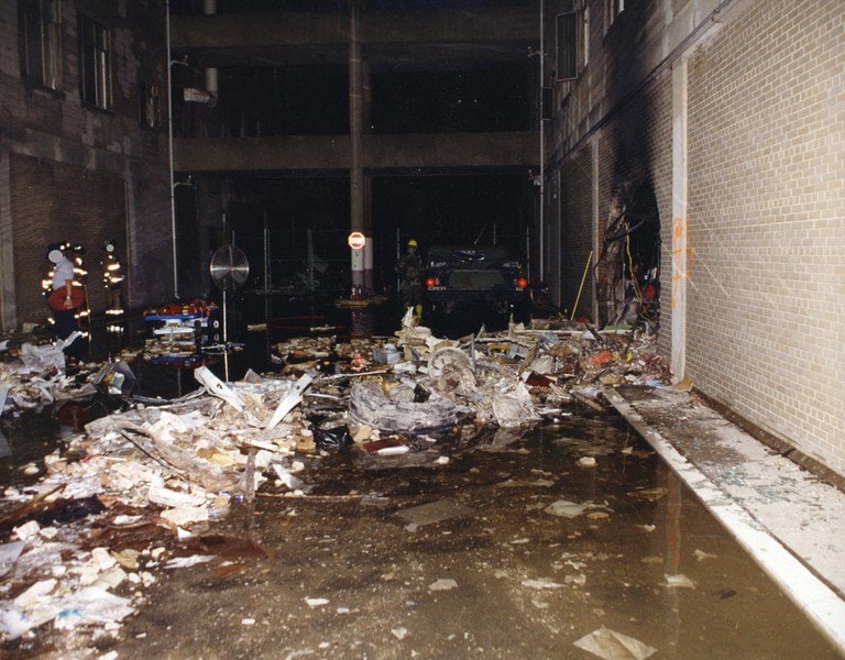 An interior corridor filled with debris and standing water.