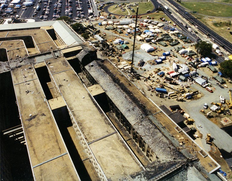 Aerial view over the damaged section, with the response camp set up alongside.