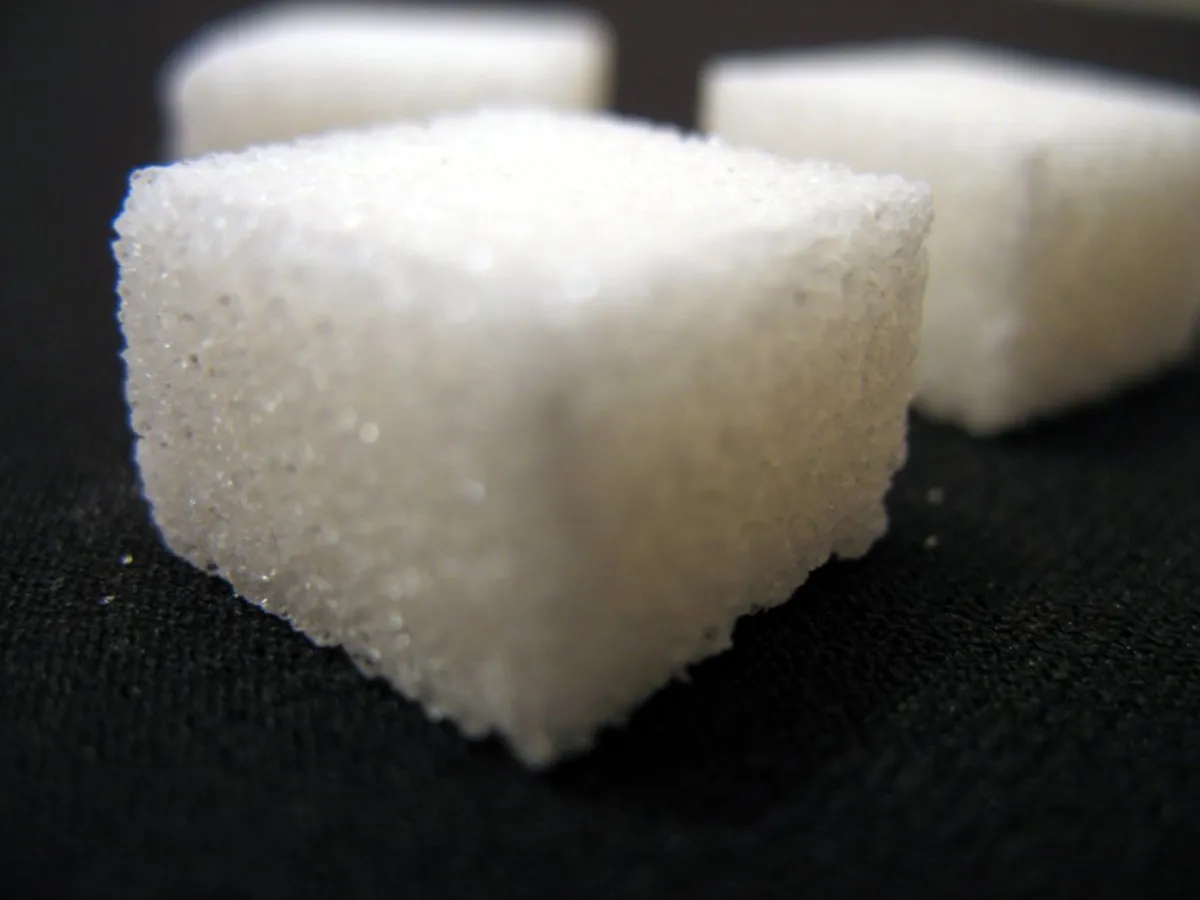 A loose heap of white sugar cubes.