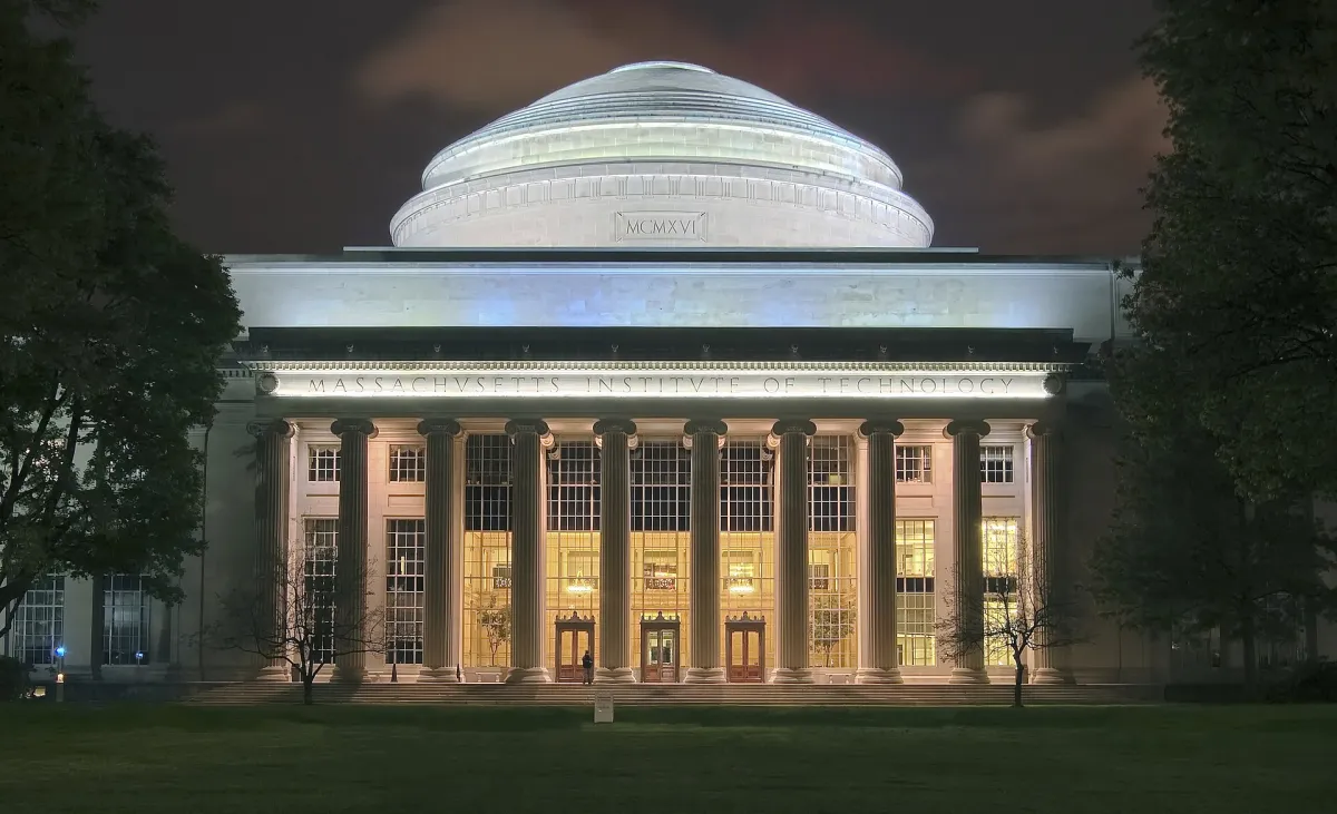 The Great Dome of the Massachusetts Institute of Technology lit at night, with its columned portico below.
